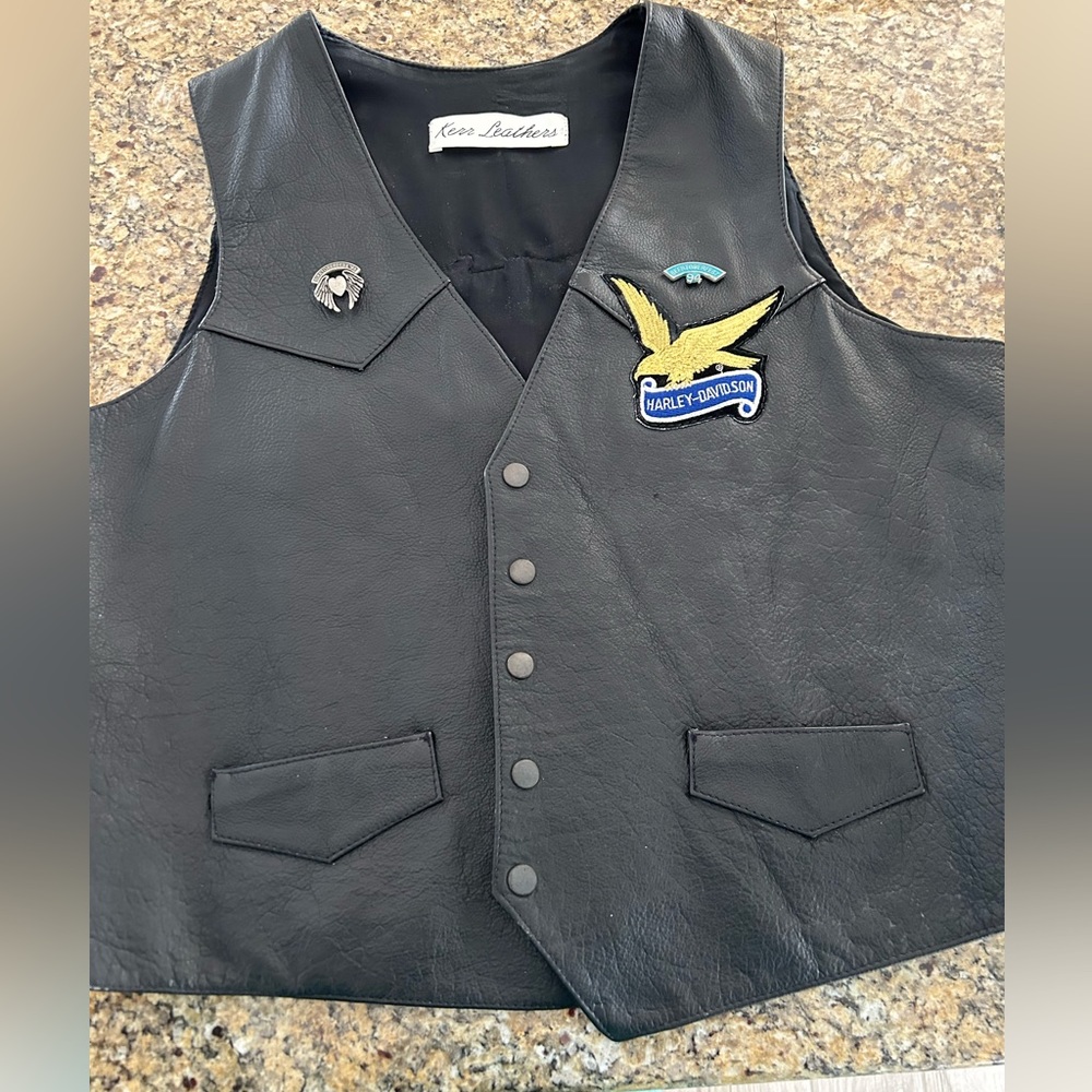 Leather vest with Harley Davidson patches.